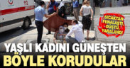 Vatandaşlar, sıcaktan etkilenip yere düşen kadını güneşten korumak için seferber oldu