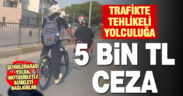 Motosiklete bağladığı iple ana yolda bisikleti çeken sürücü cezasız kalmadı