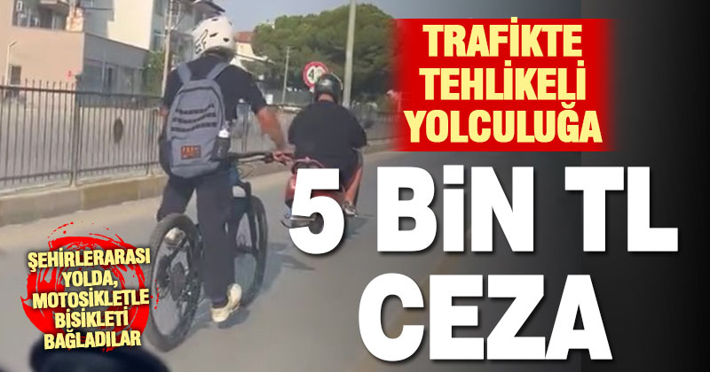 Motosiklete bağladığı iple ana yolda bisikleti çeken sürücü cezasız kalmadı